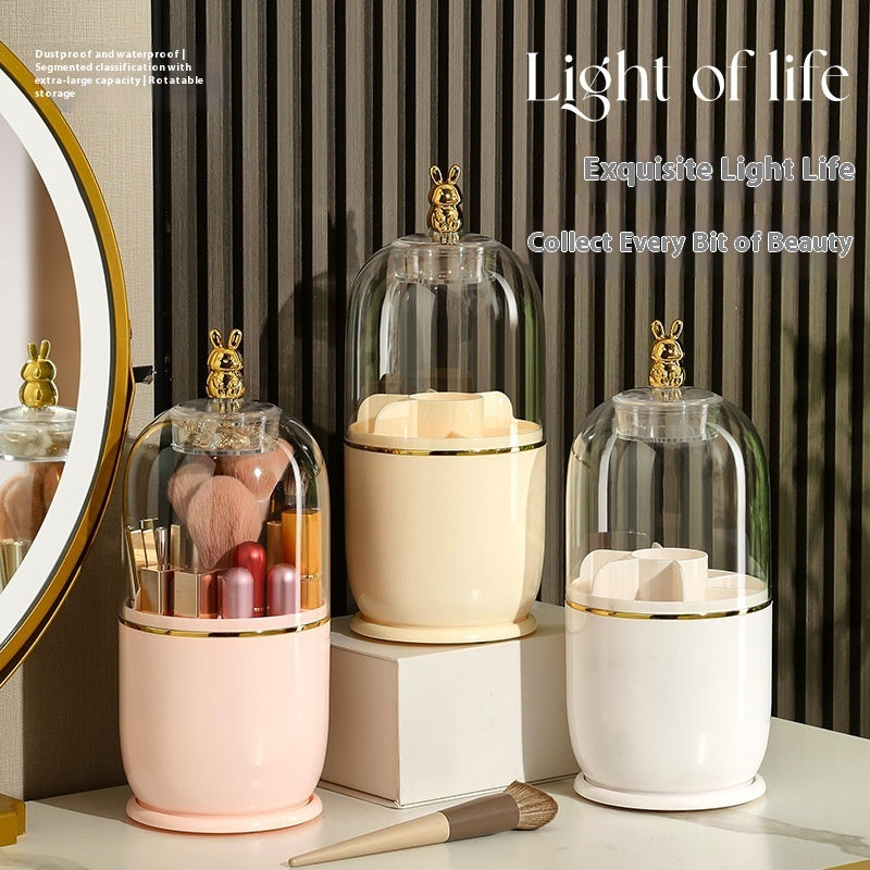 Makeup brush holder in white pink, cream and apricot. The makeup holder has a transparent casing at the top and coloured at the bottom. 